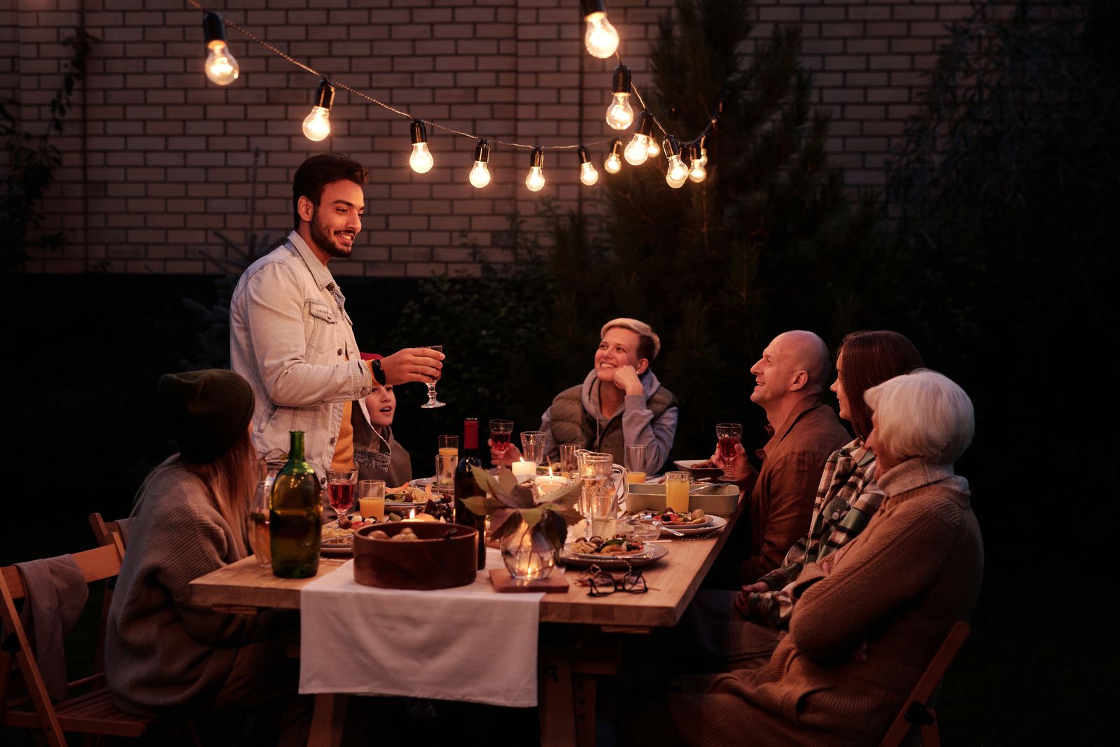 Several families sharing an outdoor dinner during group travel abroad